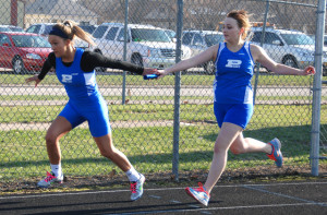 Mary Wilhelmi takes a hand off in last year's Davis Relays.