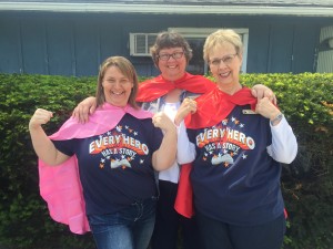 Librarians Misty Von Behren, Suzanne Kestel and Marlene Johnson show off their superhero capes.