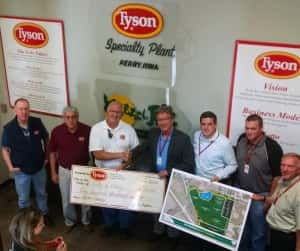 Tyson Plant Manager Mike Grothe presents Perry Mayor Jay Pattee with a $100,000 dollar check to be used in the construction of the new Pattee Park Soccer Complex.  Photo from left to right  (Tyson Chaplan Steve Murdock, Tyson's Alberto Olguin, Tysons Mike Grothe, Perry Mayor Jay Pattee, Perry City Administrator Sven Peterson, Perry Parks and Recreation Director John Anderson and Bill Clark.