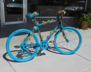 Yarn bombed bike in front of Fudge's Flowers and Gifts