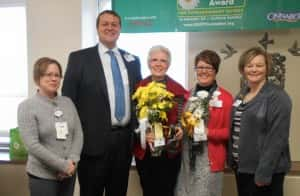 Laine Custer (pictured in the middle) receiving her award