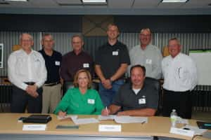 Executive Committee and CEOs sign plan of merger.  Photo courtesy of West Central.