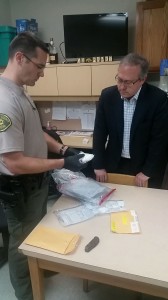 Deputy Kent Gries shows Congressman Young drugs recovered during a recent bust. 