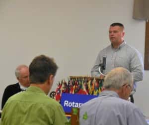 Jack Williams (standing right) speaking at a Rotary meeting