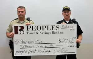 Chief Deputy Jack Williams (left) and Jefferson Police Chief Mark Clouse (right) accept anonymous donation check