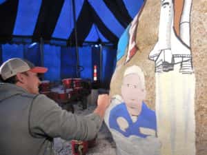 Bubba Sorensen (left) paints part of Greene County's Freedom Rock