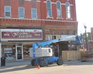 Olson Clothing sign above Fudge's Flowers