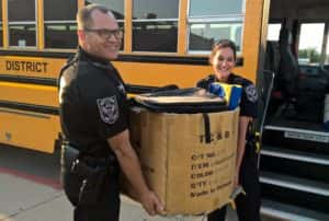 Perry police officers donated a box full of backpacks to the supply drive