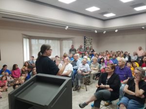 Library Director Mary Murphy welcoming people of all ages