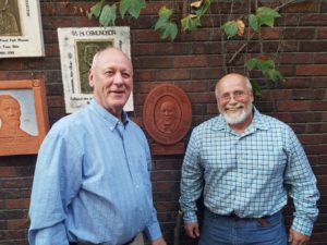 Jim Walstrom (left) and sculptor Rick Stewart with Walstrom's relief on the Wall of Witnesses