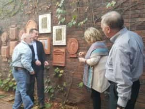 The new relief is unveiled by the sculptor and Walstrom's family