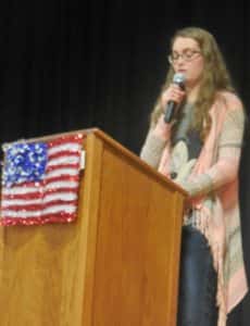 Student Council President Reagan Lamoureux talking at the Veterans Day program Friday