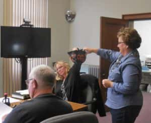 Supervisor Dawn Rudolph (middle) reaches to draw name from hat