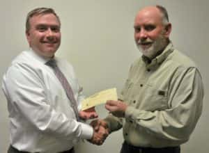 RVR GM John McGee (left) giving check to Christmas Cash Giveaway winner Dave Davis (right)