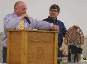 Auctioneer John Schaben (left) and Cattlemen President Tom Lawton (right) auctioning off an item in memory of Pat Fields for the scholarship fund 