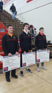 ADM wrestlers (from left to right) Kaden Sutton (220), Nolan Harsh (152), and Andrew Flora (113) pose for a picture after winning their district brackets and advancing to the state wrestling tournament. Photo courtesy of ADM Wrestling's Twitter Page. 