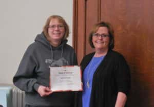 Supervisor Vice-Chair Dawn Rudolph (left) handing County Recorder Marcia Tasler (right) a certificate for 40 years of service to the county