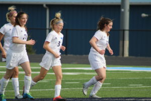 Panorama freshman soccer players (from left to right) Paige Cmelik, Ella Waddle, and Audrey Cmelik trot towards their defensive end after scoring one of their 12 goals against Grand View Christian on April 12. Photo courtesy of Panorama junior Jake Holwegner.