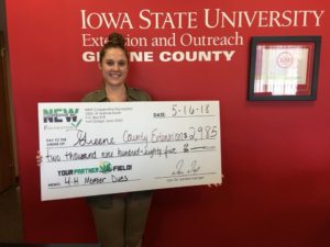 Tressa Rasmussen holding donation check. Photo courtesy of GC Extension