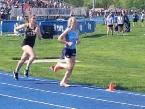 Panorama freshman Ella Waddle (blue shirt) holds off AC/GC sophomore Kate Crawford during the second lap of the 3000 meter run at the Van Meter State Qualifying Meet. Photo by RVR's Nate Gonner. 