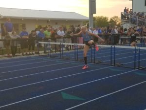 Panorama junior Morgan Johnk clears the final hurdle before winning the 100 meter hurdles race at the Van Meter State Qualifying Meet May 10. Photo by RVR's Nate Gonner