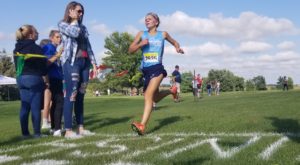 Panorama sophomore Ella Waddle crosses the finish line well ahead of the field at Thursday's Wildcat Cross Country Invitational in Menlo. Photo by RVR's Nate Gonner. 