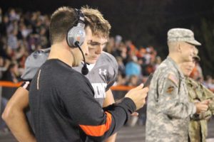 New Adel-Desoto-Minburn Garrison Carter (black shirt) shares information with his former quarterback Ryan Reighard on the sideline. Photo courtesy of Susan Harshman/Garrison Carter. 