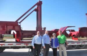 Ernst with Bauer Built reps and GCDC Exe. Dir. Ken Paxton (right) in front of a chaise for a forklift. 