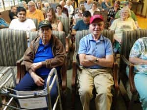 "Larry" Dominquez (left) and Paul Scott (right) awaiting Senator Joni Ernst to receive their medals