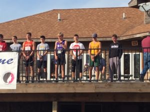 West Central Valley junior Louden Foster (purple jersey) stands on the deck of the Lakeside Municipal Golf Course receiving an all-state medal after a fifth place finish in the Class 1A State Race. Photo by RVR's James Maertens