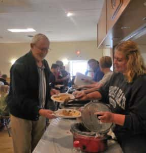 Kiwanis member Lisa Kuhl (right) serves breakfast during annual fundraiser 