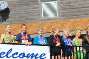 Panorama sophomore Ella Waddle (third girl from the left) stands on the deck of Lakeside Municipal Golf Course in Fort Dodge after a fifth place finish in the Class 1A State Cross Country Race. Photo courtesy of Panorama Cross Country/Jaime Waddle