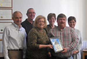 Bell Tower Community Foundation President Carole Custer (front left) handing Supervisor Pete Bardole (front right) a certificate in honor of "dedication of bells"