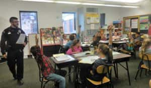 Officer Caleb Jans (left) teaching first DARE class to P-C 5th graders Thursday