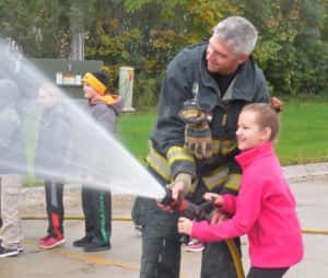 Scott Weber (standing left) with a 4th grade student