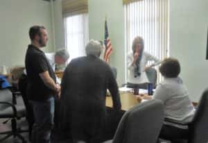 The recount committee goes over the final totals with County Auditor Jane Heun (standing right) and Deputy Auditor Billie Hoskins (sitting right) on Wednesday