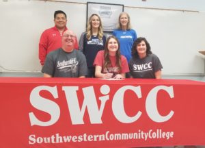 Brooke Halterman (front middle) signs her letter of intent to play college volleyball for Southwestern Iowa Community College in Creston. Photo by RVR's Nate Gonner. 