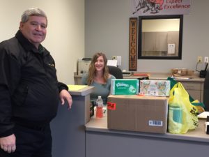 Kiwanis President Tom Heater (left) donating items to elementary secretary Jill Lamoureux (right). Photo courtesy of Kiwanis Club