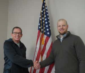 Mayor Craig Berry (left) shaking hands with newly hired police officer Andrew Chapman (right)