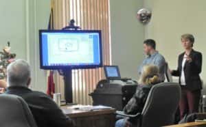 Emmett Konrad (standing left) and Holly Elbert (standing right) with Brooks, Borg and Skiles presenting HVAC plans to Supervisors