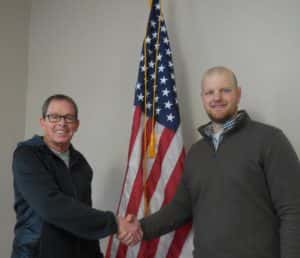 Andrew Chapman (right) became an officer on December 28th. He is shaking hands with Jefferson Major Craig Berry (left) following a special city council meeting on Dec. 21st