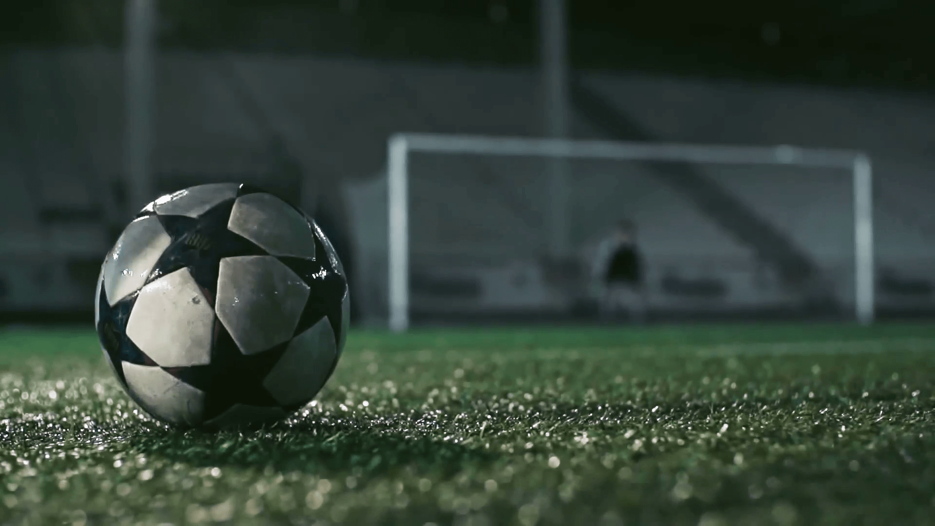 low-angle-view-of-feet-of-soccer-player-kicking-wet-ball-on-misty-grass-in-the-night-stadium-in-slow-motion_bkrpswow__f0000