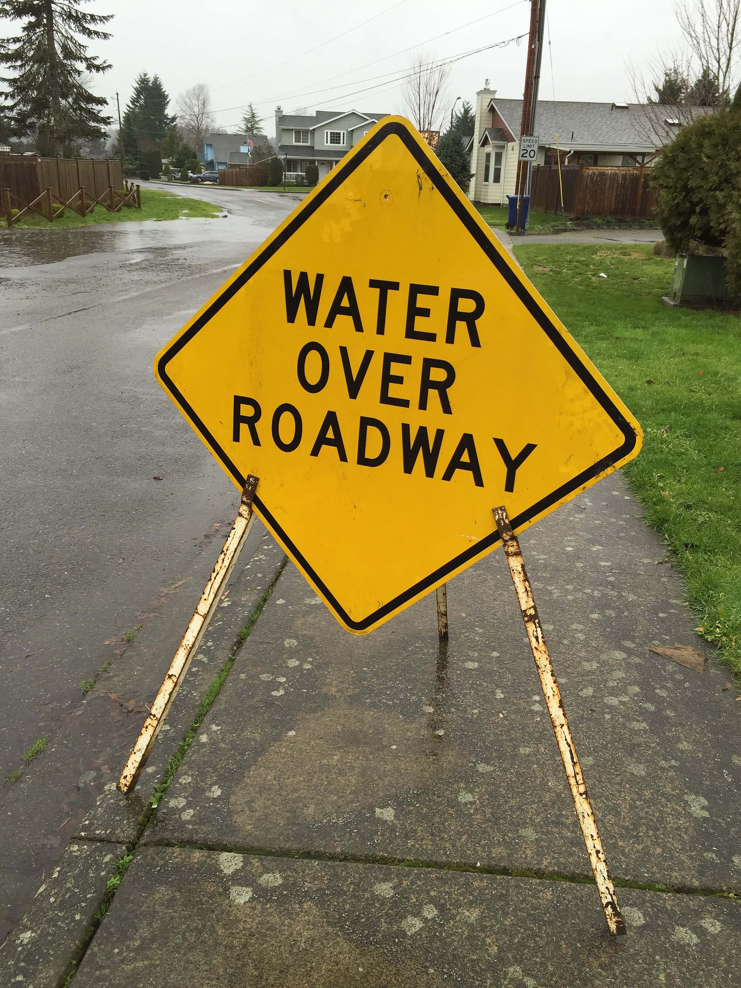 2448px-water_over_roadway_warning_road_signs