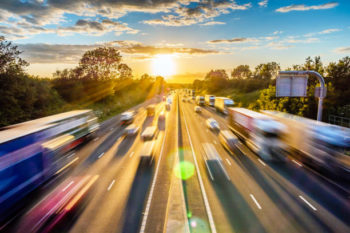 heavy-traffic-moving-at-speed-on-uk-motorway-in-england-at-sunset