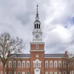 Photo of Baker-Berry Library^ Dartmouth College located in Hanover^ New Hampshire^ USA on a mostly cloudy spring day. Hanover^ NH^ USA - 04-21-2024