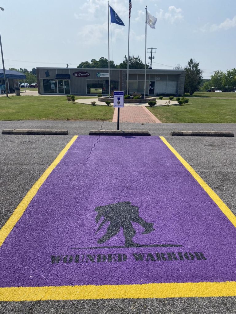 Adams Contracting Painting 'Purple Heart' Parking Spaces Around The