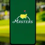 Smartphone displaying The Masters golf tournament logo on a green screen^ set against a blurred background^ representing professional sports media and tournament coverage. Kaunas^ Lithuania - 2026 March 12
