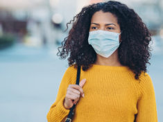 young-woman-walking-outdoors-with-a-face-mask