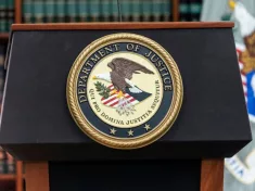 Seal of Justice Department seen during press conference at US Attorney Office library