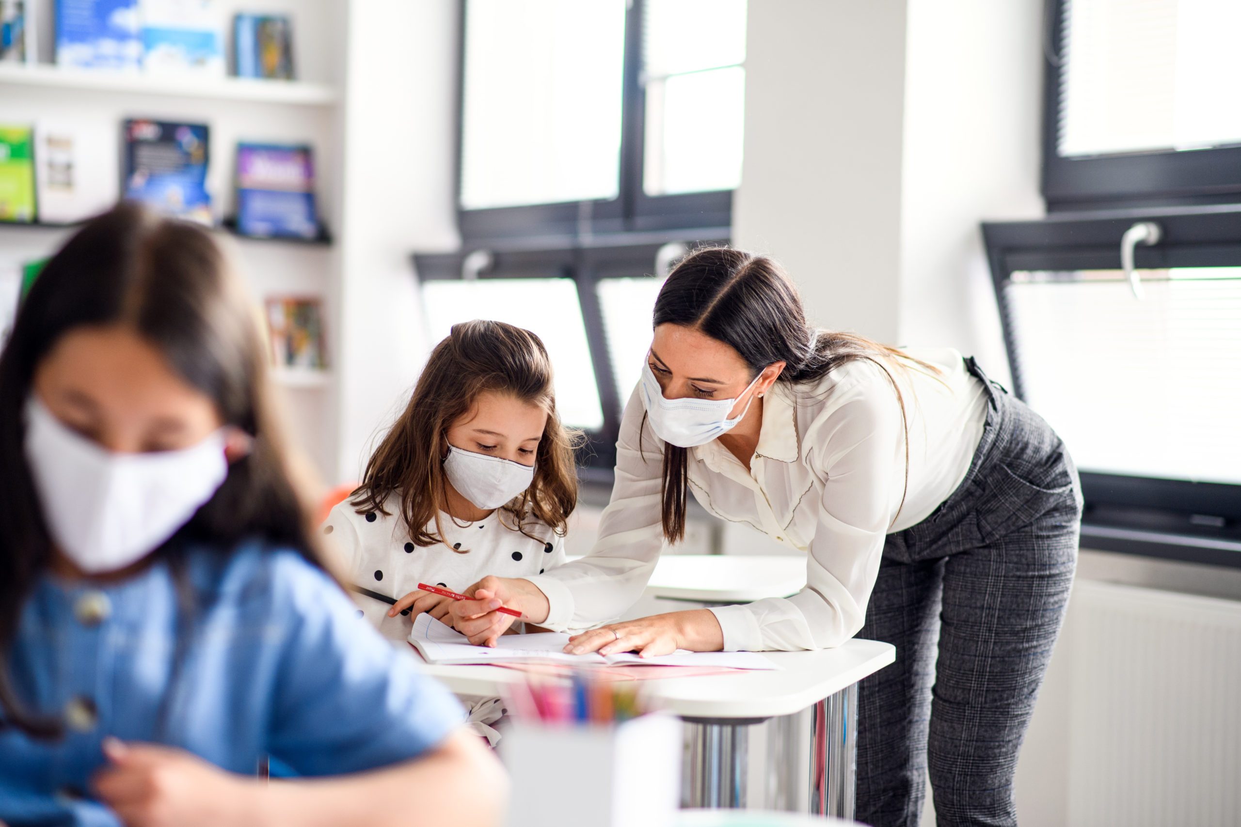 teacher-and-children-with-face-mask-back-at-school-after-covid-19-quarantine-and-lockdown